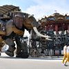 – People stands on a mechanical elephant made of wood and steel at "Les Machines de L'Ile" ("Machines of the Isle of Nantes") in Nantes, western France, on June 20, 2017 as people look at it.
It walks its 48-ton metal carcass every day in Nantes, but its barrier is famous even in the United States: the Grand Elephant launched ten years ago by "Machines of the island of Nantes", a bestiary of monumental creatures which have made the city famous abroad. / AFP PHOTO / LOIC VENANCE
